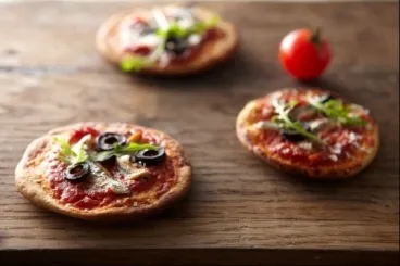 Petites pizzas aux saveurs d'anchois, de roquette et d'olives noires